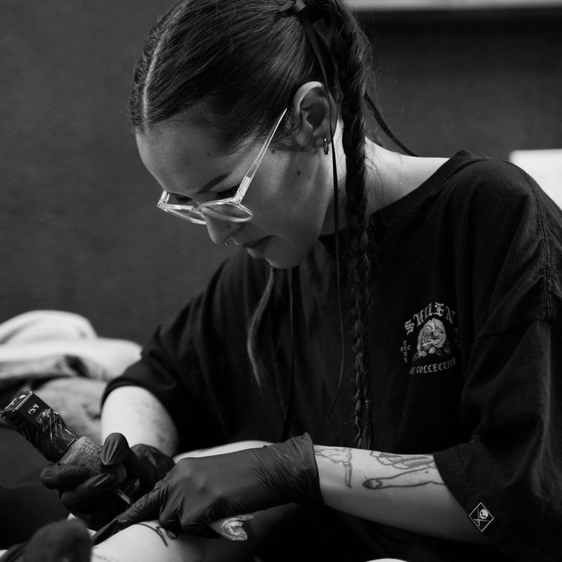 Hailey tattooing at Pale Horse Collective